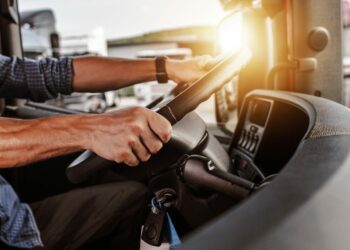 CDL Commercial Driver Inside of His Truck. Transportation Industry Theme.